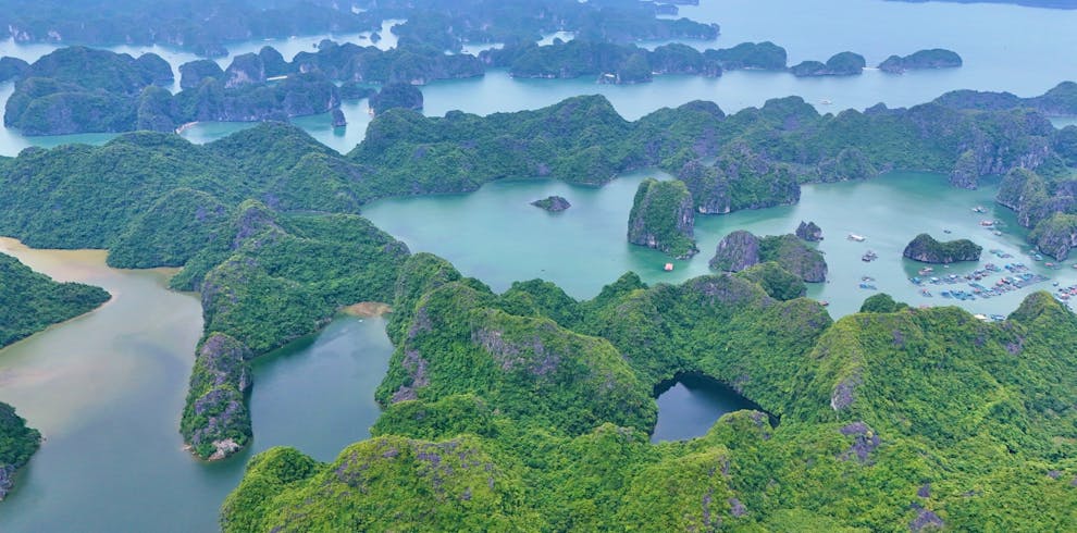 Stunning aerial shot of Ha Long Bay's lush green islands and tranquil waters in Vietnam.